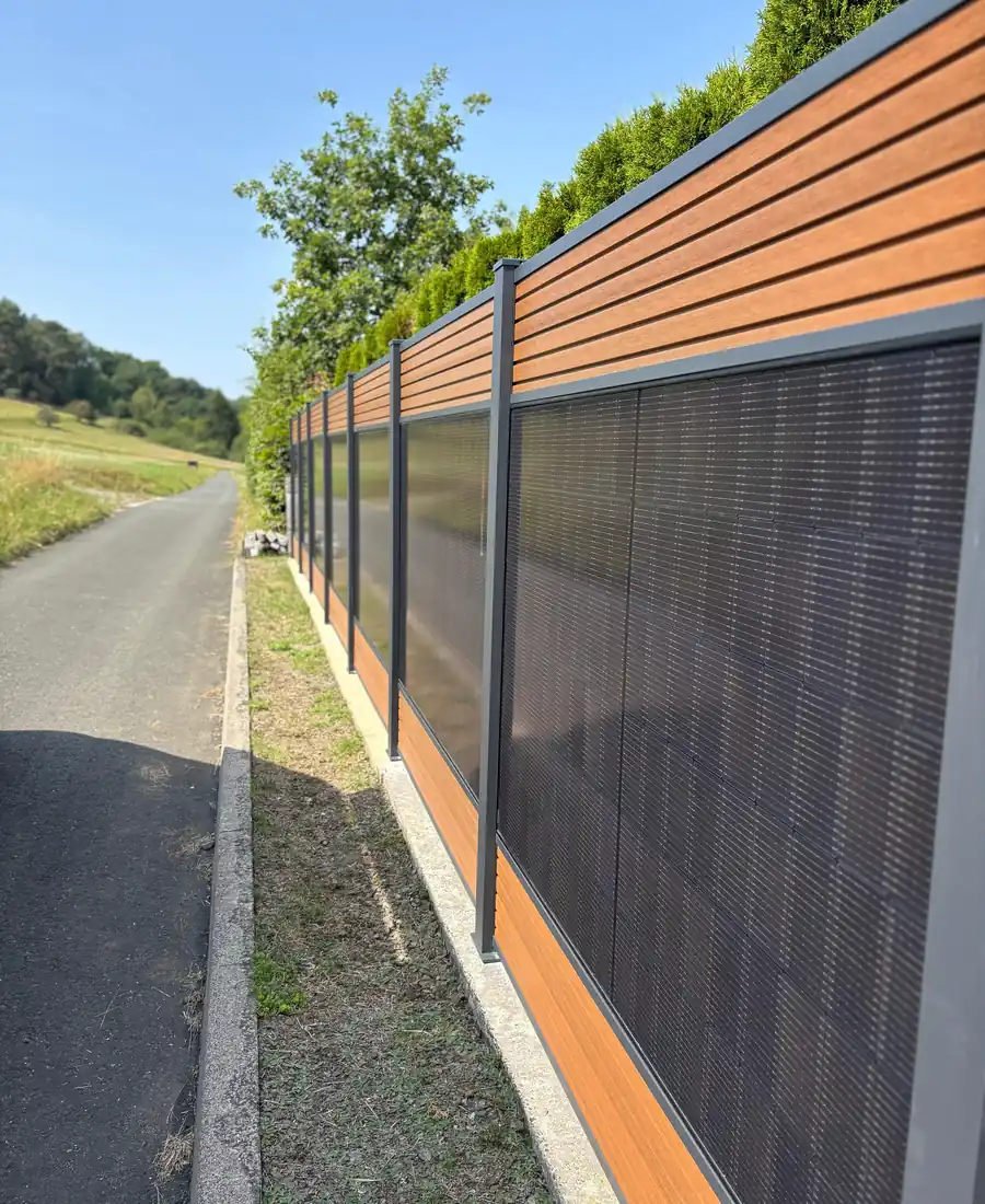 Solar-Sichtschutzzaun mit Photovoltaik-Modulen und Profilen in Teakoptik